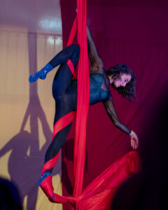A woman doing an aerial silks performance